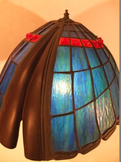 Tiffanylampe mit Bronzefigur Material: Glas/ Metall Motiv: Figur / Engel die Lampe hoch hält Maße: 66 x 43 cm Gewicht: 15 kg